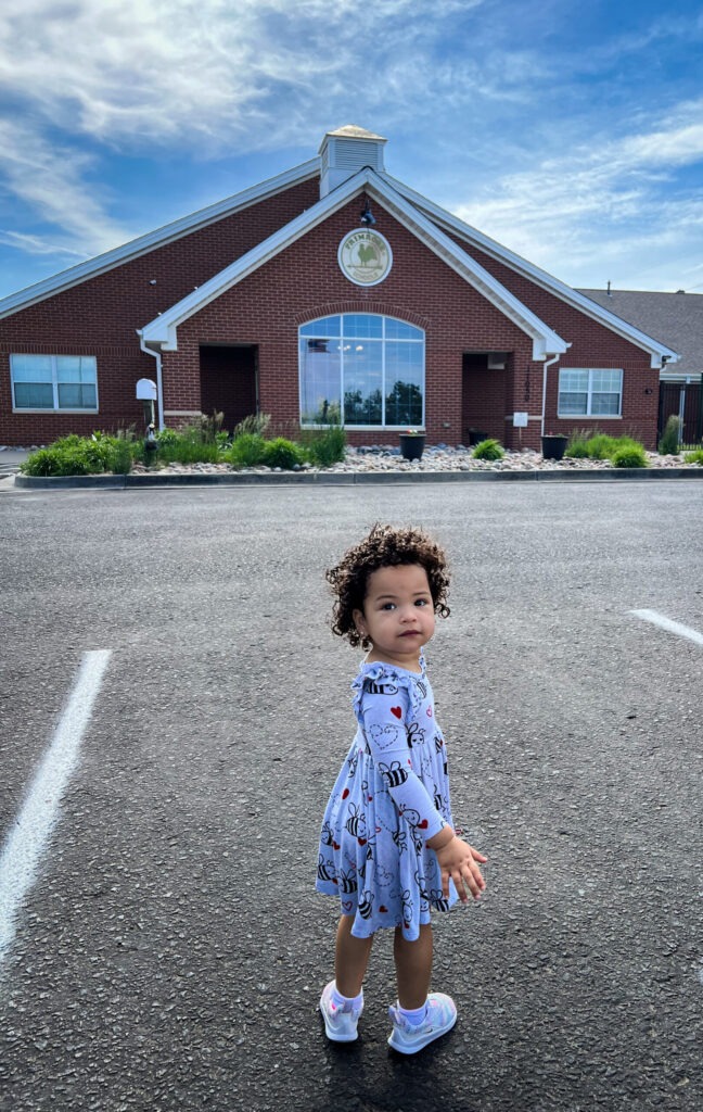 Toddler in front of Primrose School starting daycare