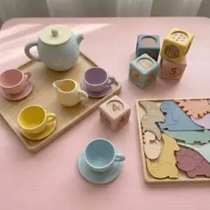 Baby Bertie Montessori silicone toy collection featuring pastel tea set, numbered counting blocks, and dinosaur puzzle for toddler development