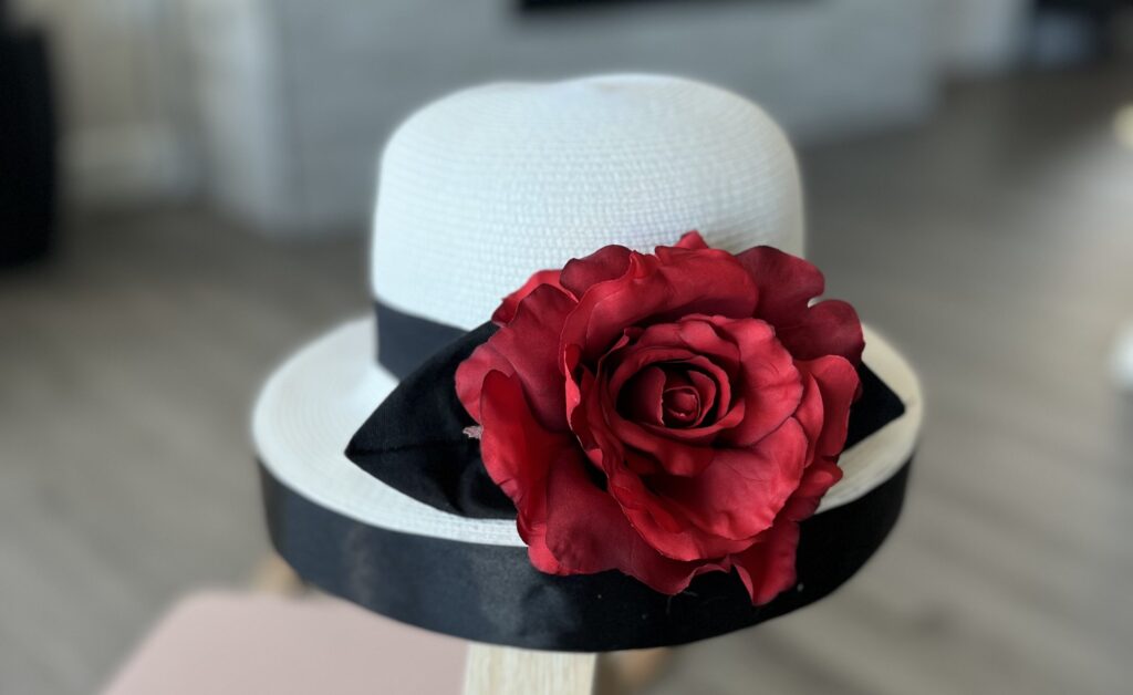 Finished homemade Dionne hat for a Cher and Dionne costume with black ribbon and red rose